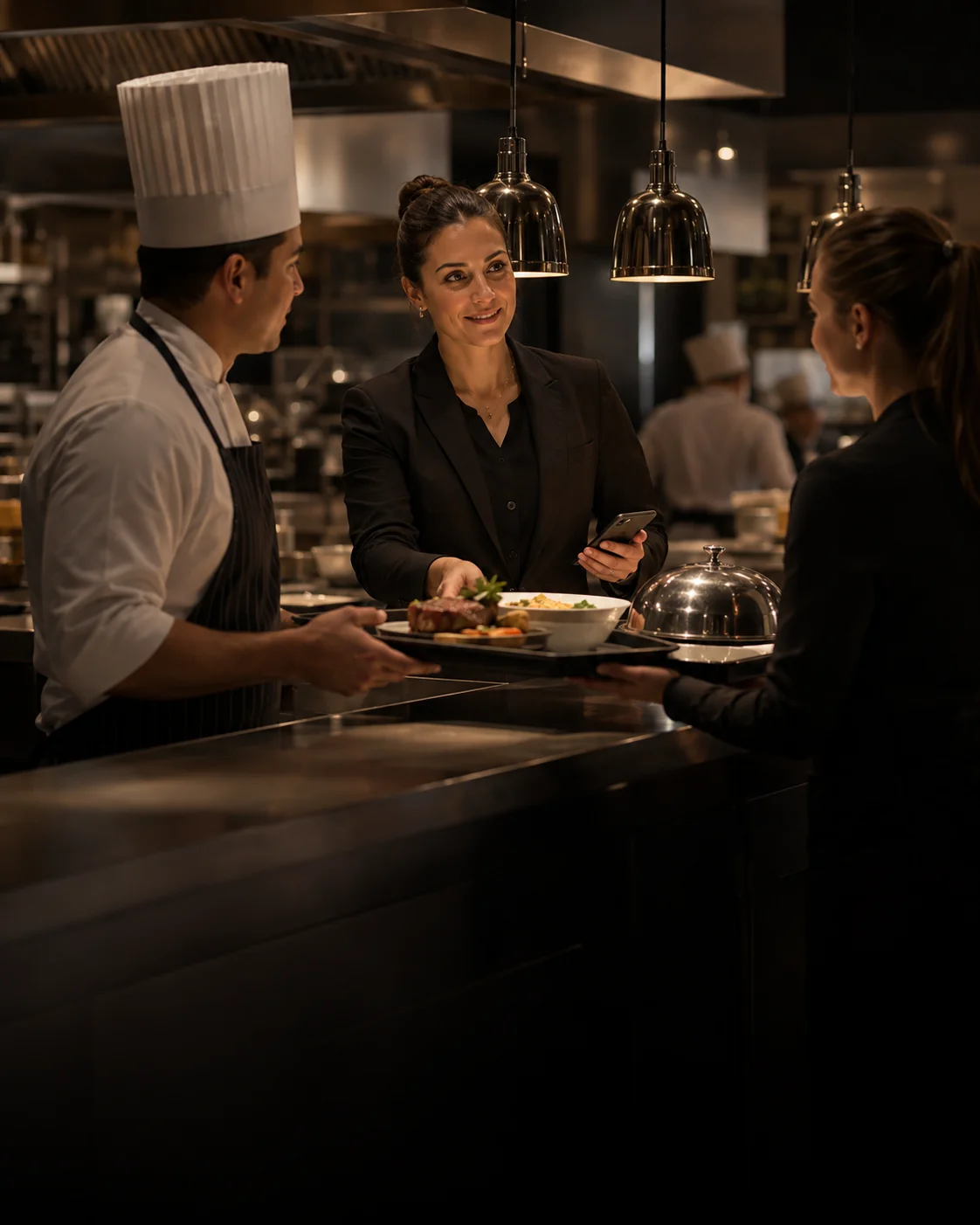 A hotel expeditor coordinating a room service handoff with culinary and Front of House colleagues