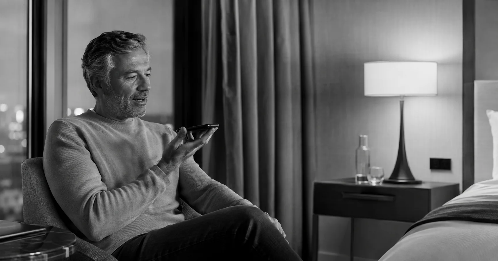 A hotel guest making a natural spoken request from the room